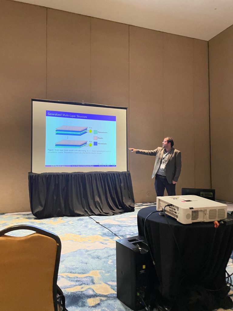 Ahmet Kaan Aydin presenting multilayer beam research at the IEEE Conference on Decision and Control